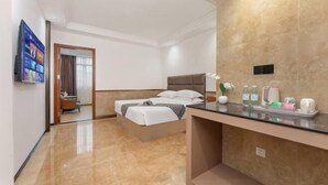 A hotel room with a bed, a desk, a TV, and a bathroom visible through an open door. - Boying Business Hotel (Jiangmen)