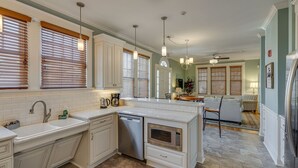 A spacious kitchen with white cabinetry, a dishwasher, an oven, and a large island. - Historic 4-Bedroom Manor | Walk to Music Row & Vanderbilt | Family Retreat (Nashville)