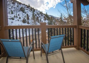 A balcony with two chairs facing a snowy mountain view. - Charlie's Slopeside: Ski-In/Out, Sleeps 10, 2 Master Suites, Pool + Hot Tub, Alpine Club (Avon)