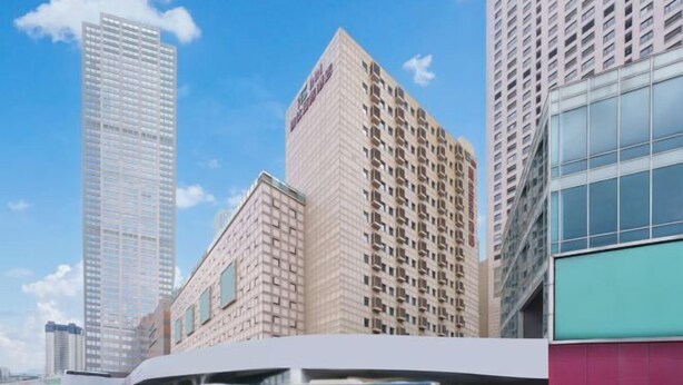 A modern building complex with multiple high-rise structures, a covered bus station, and a clear blue sky. - Longemont Yashi Business Hotel (Zhongjie Street，Shenyang) (Shenyang)