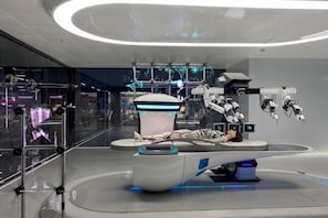 A futuristic interior with robotic elements and a central circular platform. - Longemont Yashi Business Hotel (Zhongjie Street，Shenyang) (Shenyang)