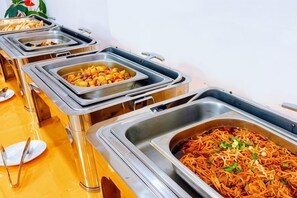 A buffet with multiple food stations, including a noodle dish and a mixed salad. - Longemont Yashi Business Hotel (Zhongjie Street，Shenyang) (Shenyang)