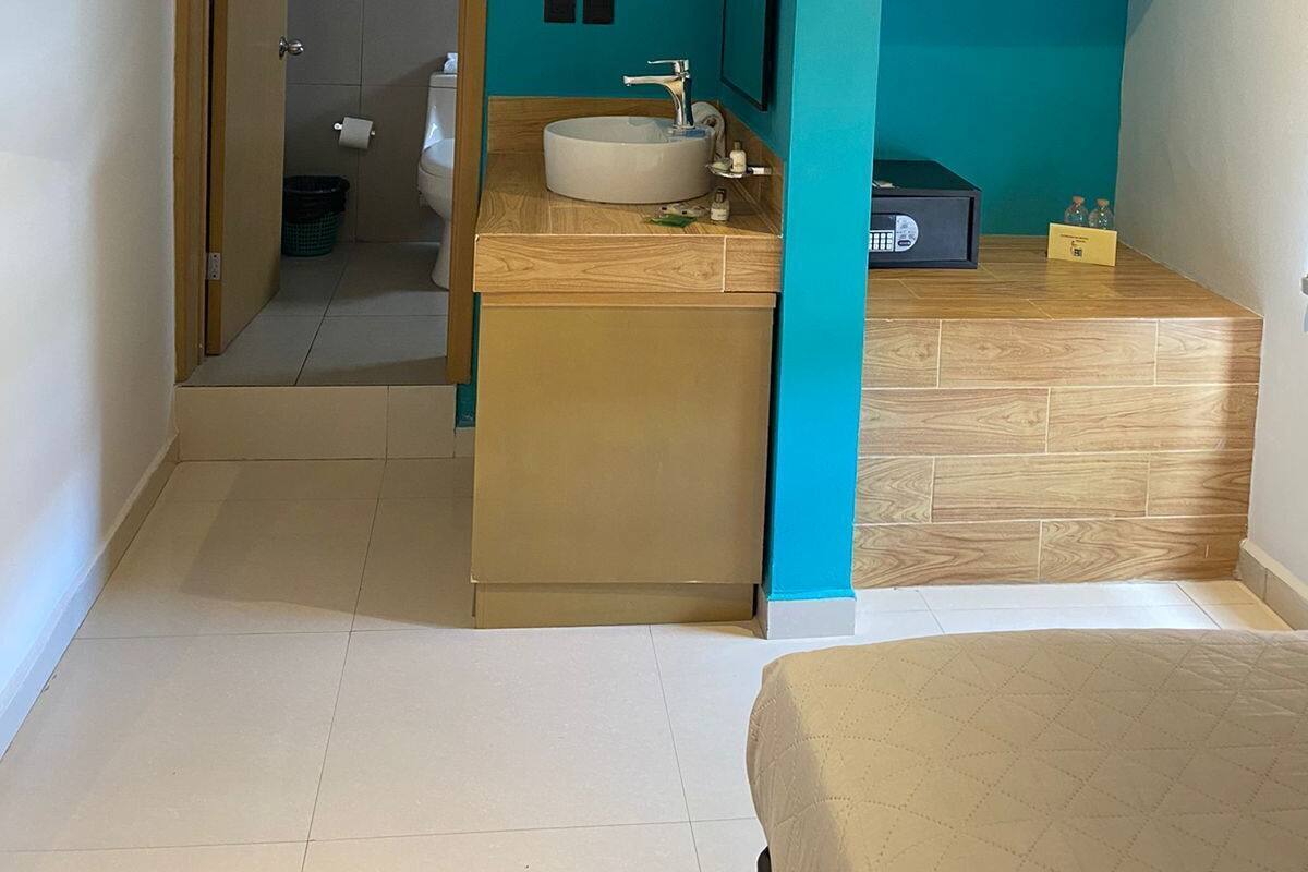 A modern bathroom with a sink, mirror, and shower area.