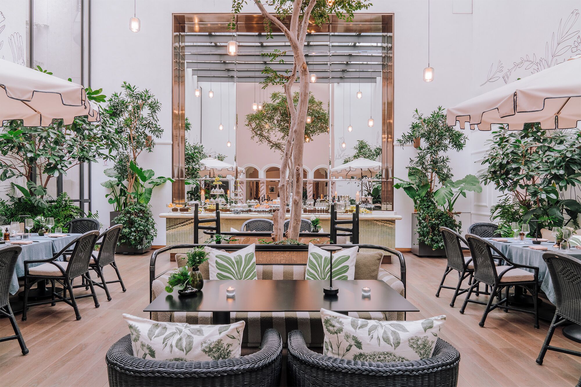 An indoor dining area with tables, chairs, and hanging lights.