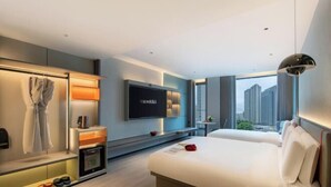 A modern hotel room with a large bed, a TV, a minibar, and a city view. - The Origin Hotel (Wenzhou Lucheng Road Guanghua Bridge) (Wenzhou)