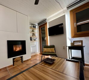 Relax in this stylish living room with a flat-screen TV, comfortable seating, and a beautiful rug.