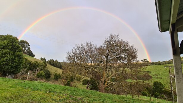 A rural landscape with a rainbow arching over a hill. - Foster - Nature Retreat -  Nippards Nature Cottage (Woorarra West)