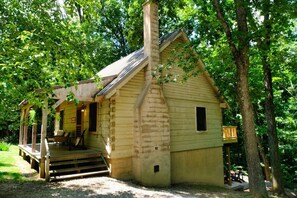 A rustic cabin with a porch, a chimney, and a small window. - The Roost cabin Hocking Hills (with WiFi) (Rockbridge)