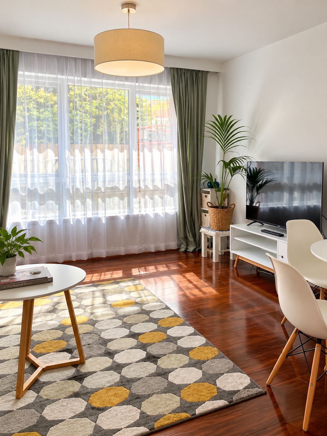 A modern living room with a television, a coffee table, and a sofa.