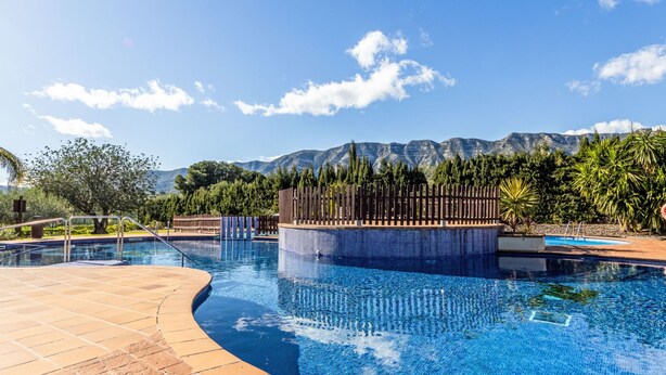 A swimming pool with a view of mountains in the background. - Golden Beach by Interhome (St Carles de la Ràpita)