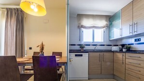 A modern kitchen with wooden cabinets, a dishwasher, and a dining area with a table and chairs. - Golden Beach by Interhome (St Carles de la Ràpita)