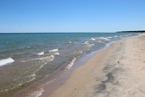 A beach with clear water and a sandy shore.