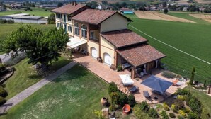 A large house with a spacious patio, surrounded by lush greenery and fields. - La Bell'aria by Interhome (Frinco)