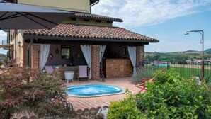 A house with a swimming pool, a covered patio, and a view of the countryside. - La Bell'aria by Interhome (Frinco)