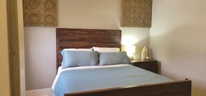 Cozy retreat with a bed, bedside table, and elegant wall panels.