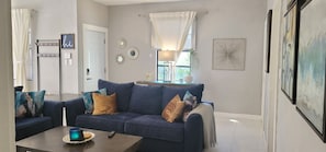 Relax in a stylish living room with a comfortable sofa, coffee table, and large window.