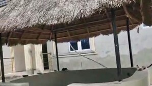 Habitació amb sòl de formigó, teulada de palla i una finestra.