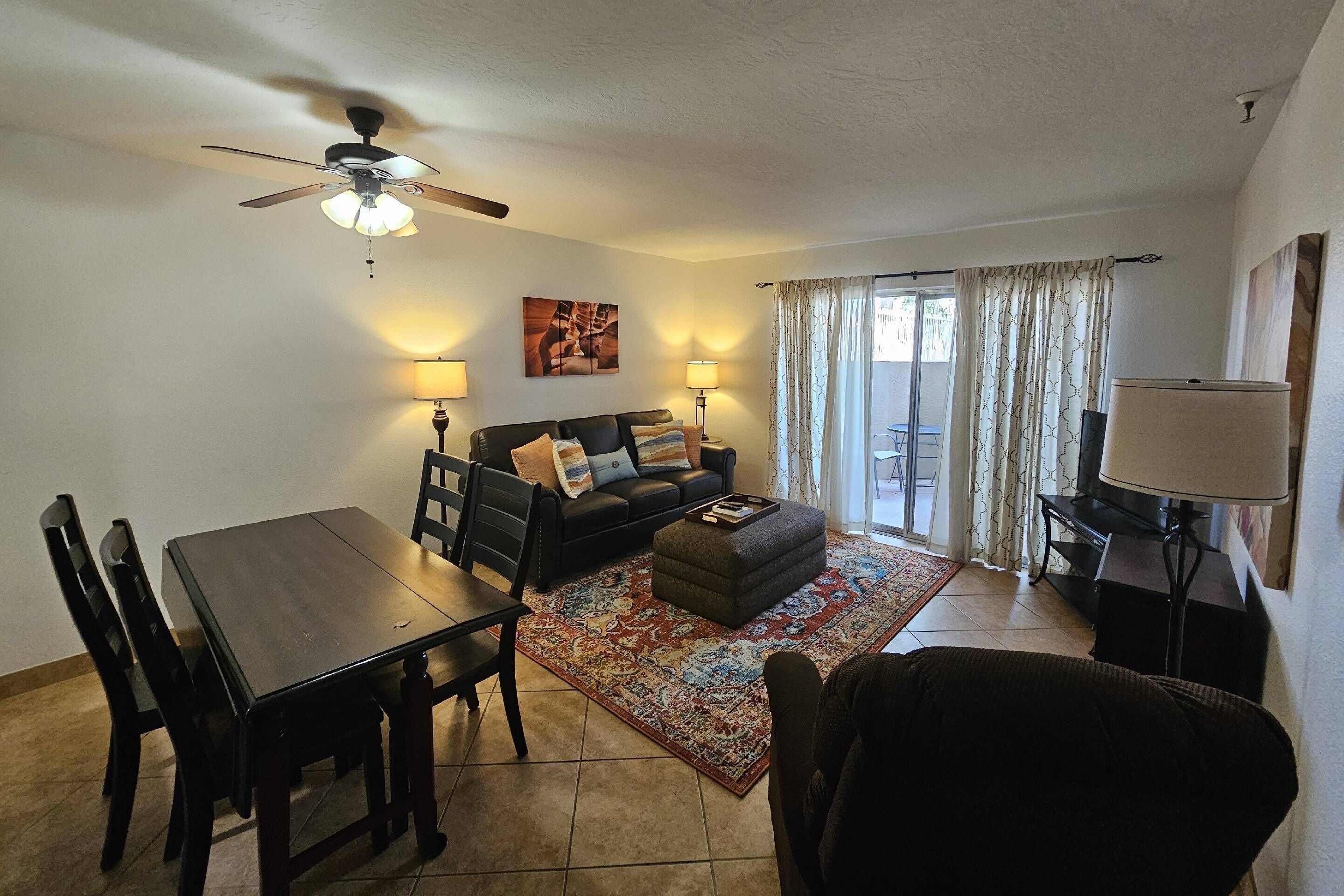 Comfy living room with sofa, chair & 40" TV & access to back patio
