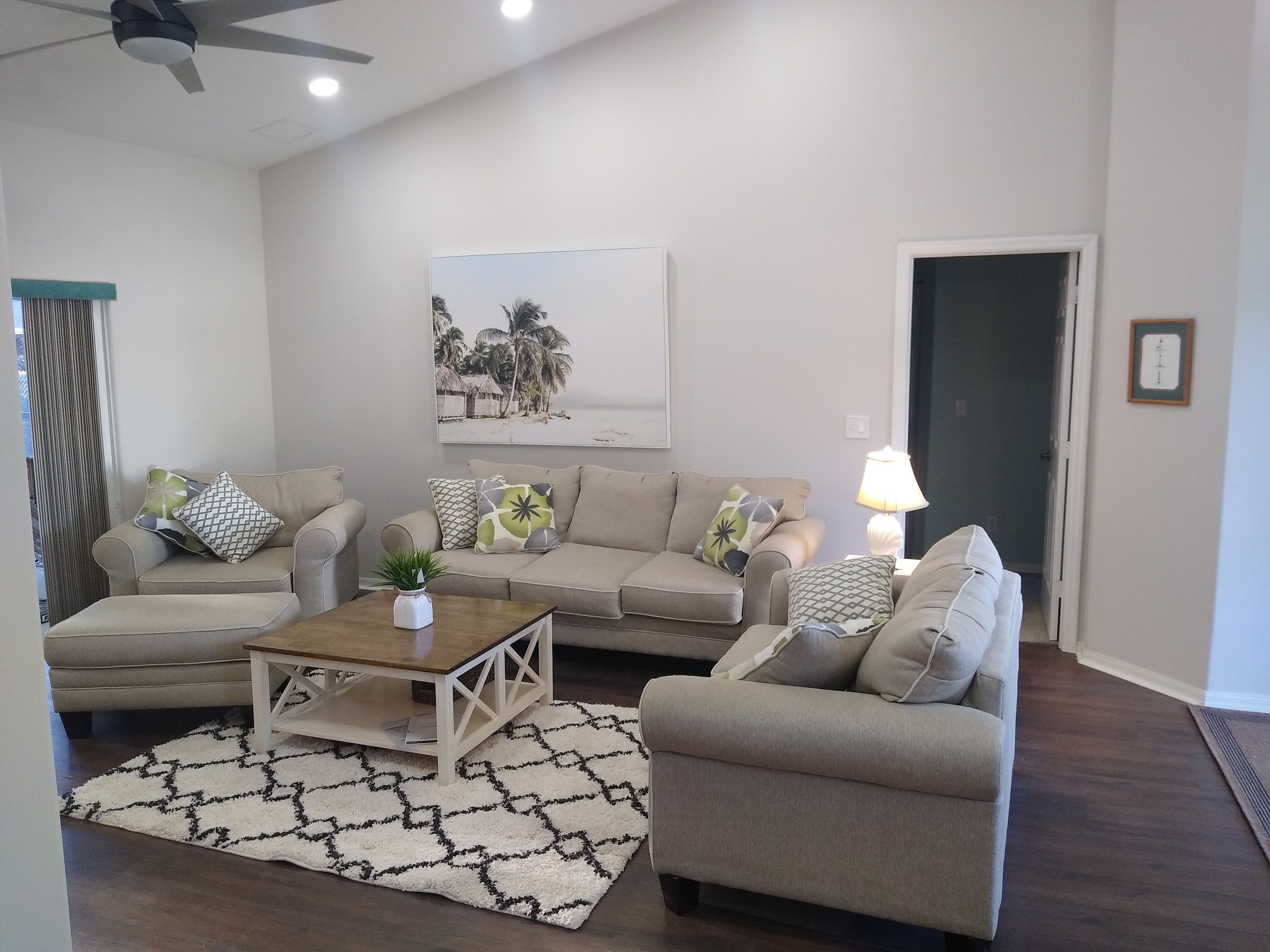 A living room with two sofas, a coffee table, and a patterned rug.