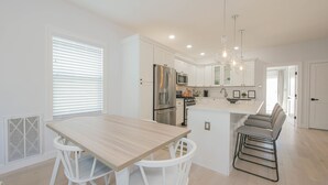 A modern kitchen with white cabinetry, stainless steel appliances, and a central island with seating. - 2 Blocks to Beach | Ventnor City | Multi- Level Decks | Pet Friendly (Ventnor City)