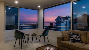 A modern living room with large windows, a sofa, two chairs, a small table, and a tray with a magazine. - Lovely and luxury apartment in Altea, Costa Blanca, Spain for 6 persons (Altea)