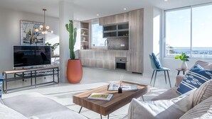 A modern living room with a flat-screen TV, a large cactus, and a dining area with a wooden table and chairs. - Lovely and luxury apartment in Altea, Costa Blanca, Spain for 6 persons (Altea)