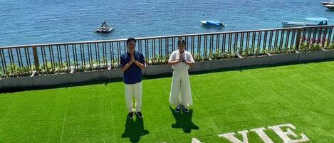 Deux personnes se tiennent sur une pelouse verdoyante, et les mots « SEA LAVIE » sont visibles au premier plan.