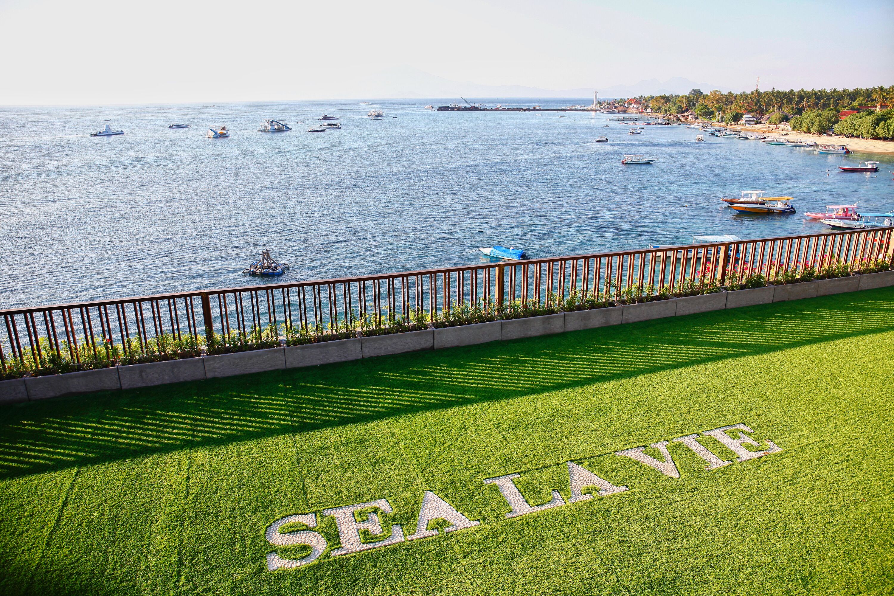 A coastal view with a grassy area marked "SEALAVIE" and a railing overlooking the sea.