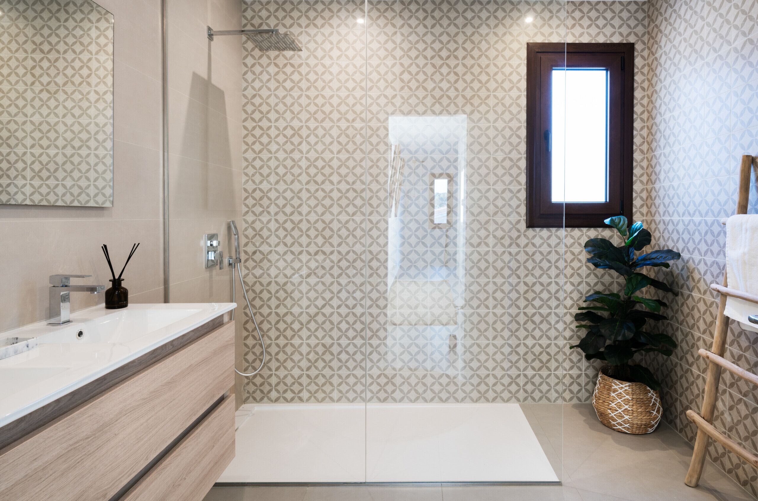 A modern bathroom with a large mirror, a shower, and a sink.