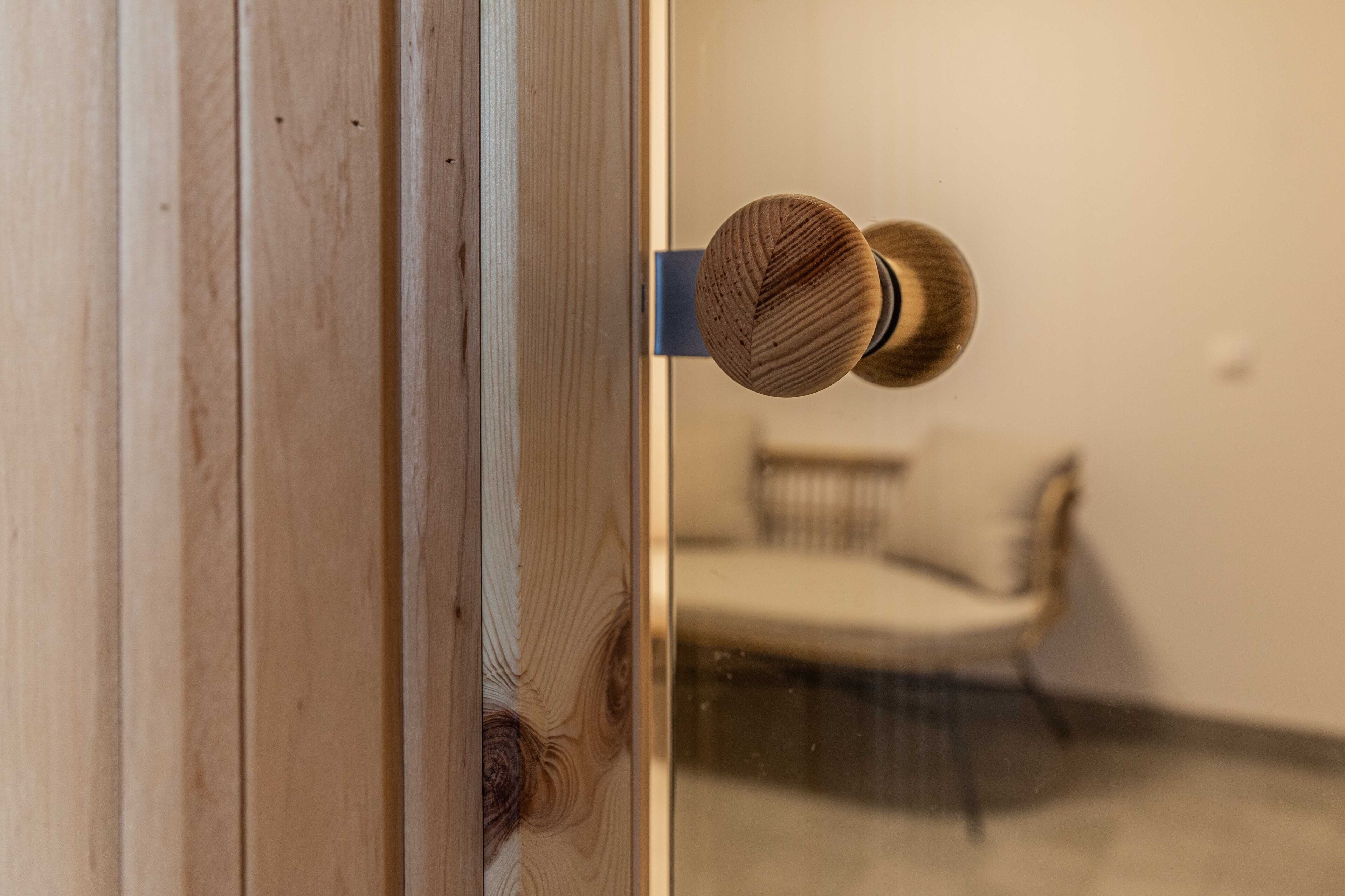 A wooden door with a round, textured knob.