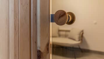 A wooden door with a round, textured knob.