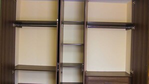 A walk-in closet with multiple shelves and a single drawer. - Stay.Plus Milimani Luxe Apartment (Kisumu)