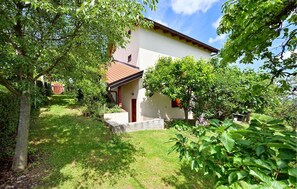 Stroll through the beautifully maintained garden to the entrance of this charming two-story home.