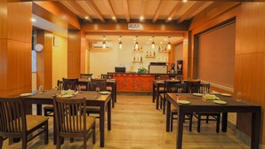 A restaurant with wooden paneling, multiple tables, and a bar area. - Lords Eco Inn Kathmandu (Kathmandu)