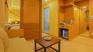 A hotel room with a wooden door, a small table with a plate of food, a minibar, and a large mirror. - Lords Eco Inn Kathmandu (Kathmandu)