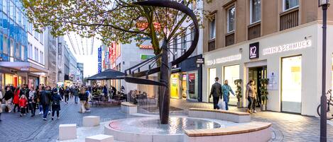 A public square with a central water feature and seating areas.