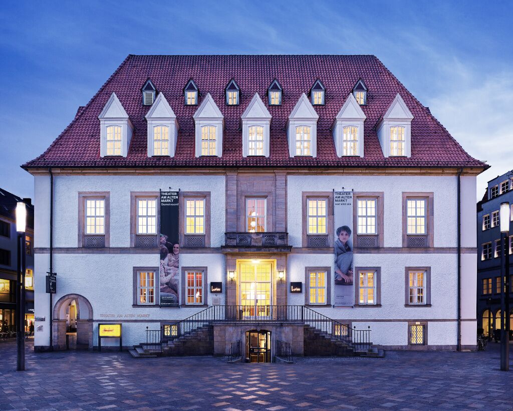 A historic building with a symmetrical facade, multiple windows, and a central entrance.