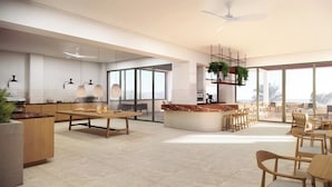 A spacious kitchen with a central island, large windows, and a ceiling fan. - Cavo Marelia (Karpathos)