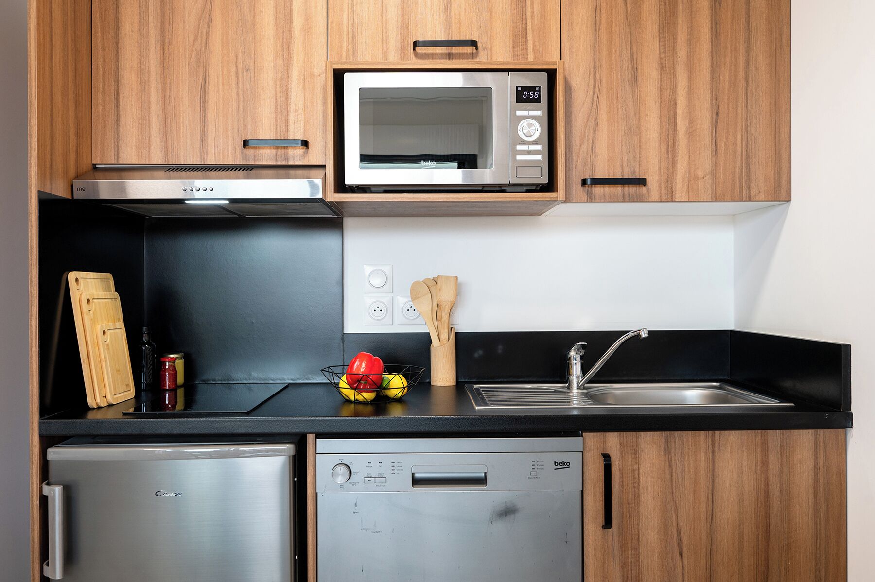 A compact kitchen with a microwave, oven, and dishwasher.