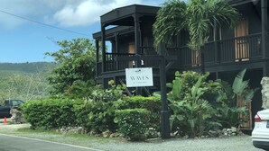 A two-story building with a sign for 'Waves at Cane Bay'. - Cliffside at Cane Bay - 3 bed/ 4 bath seaside home with private pool. (Cane Bay beach)