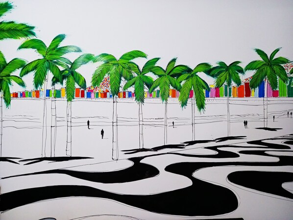 A beach scene with palm trees and colorful beach huts.