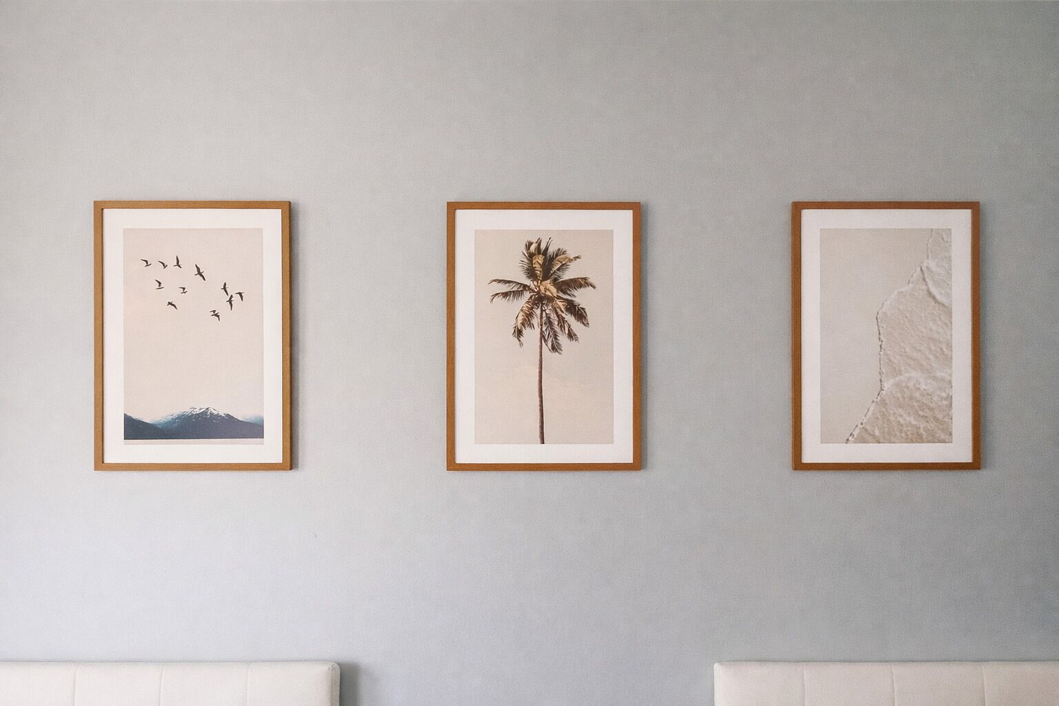 Three framed artworks on a wall.