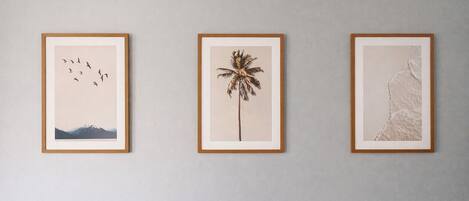 Three framed artworks on a wall.