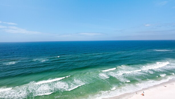 A beach with clear blue water and a sandy shore. - 1806-18th Floor-2 Bedroom-Heated Pool-HOT TUB-GRILLS-AMAZING BEACH FRONT VIEWS (Panama City Beach)