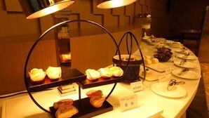A buffet setup with various food items and a sign indicating 'Japanese cuisine'. - Tianrui Hotel (Yanhe)