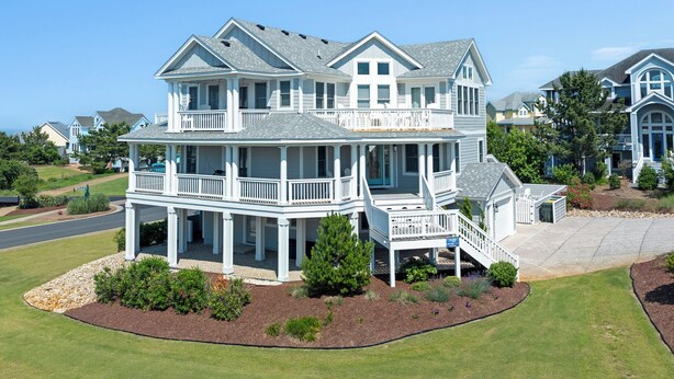 A large, two-story house with multiple balconies and a covered front porch. - It's 5 O'clock Somewhere: Pool, Spa, Club Access (Corolla)