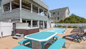 A backyard with a swimming pool, a hot tub, and outdoor seating. - Payson Place: Oceanside, Pool, Golf Discounts, Spa (Corolla)