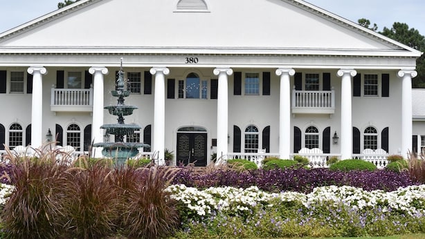 A large white building with columns and a fountain in front. - 27 Holes of Golf Surrounds the Studio Golf Villa 1606L with Resort Amenities by RedAwning (Calabash)