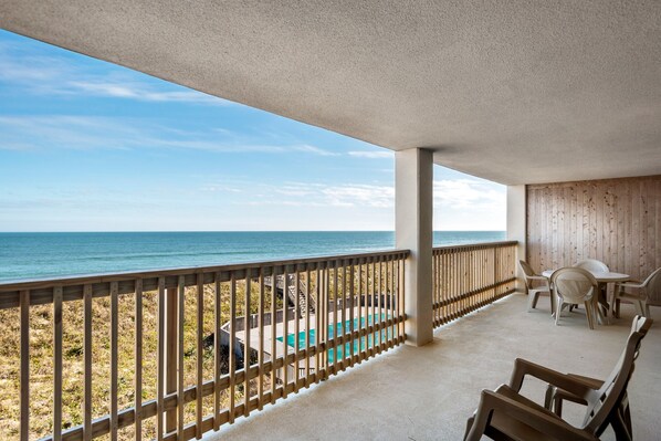 Relax by the ocean with a pool and seating area on the covered deck.
