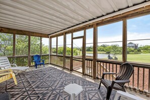 A covered outdoor area with a view of a golf course and a lake. - Linkside 3: Overlooks Golf Course, Hot Tub and Sunset Views! (Nags Head)